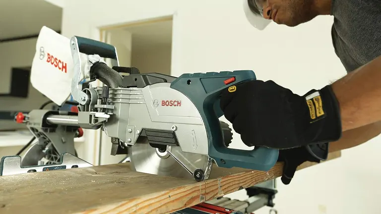 Person using a BOSCH CM8S 8-1/2” Single Bevel Sliding Compound Miter Saw on a wooden board