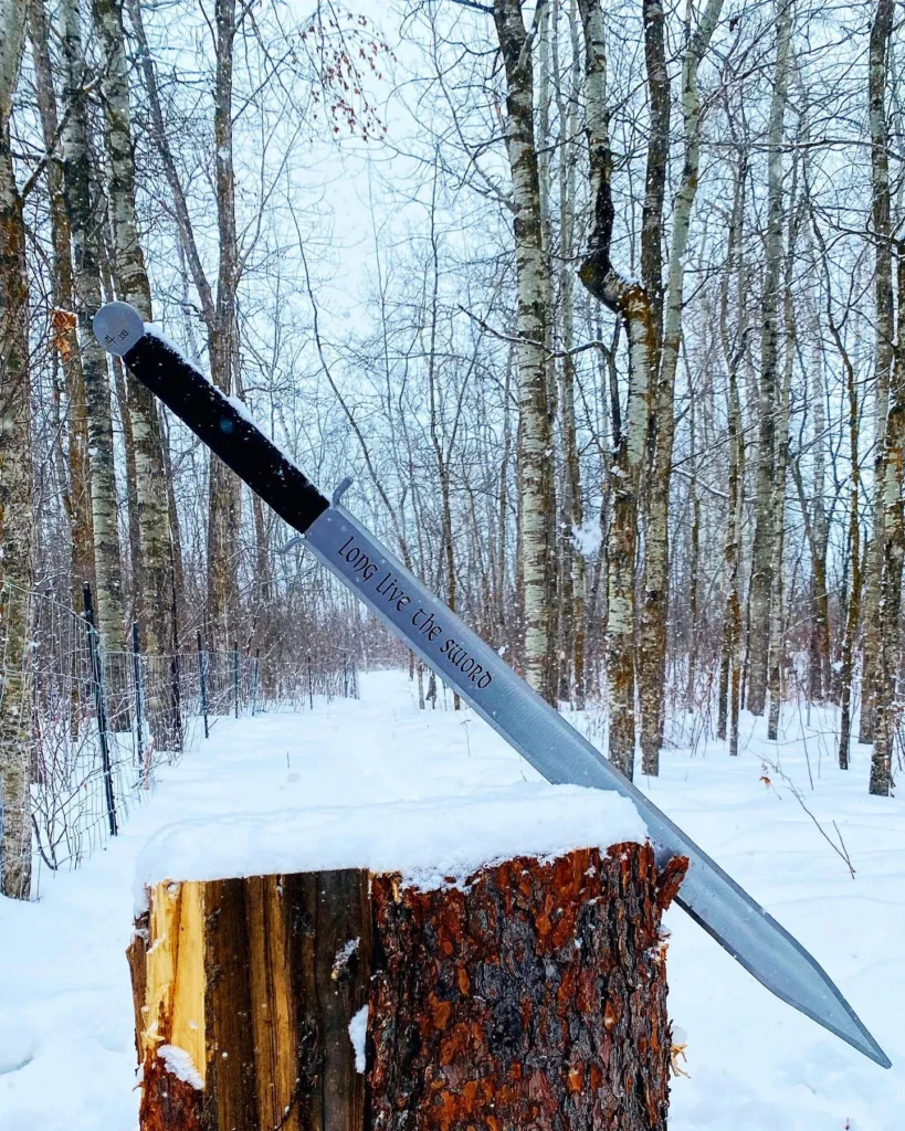 Viking Wood Splitter embedded in a snow-covered log amidst a wintry forest