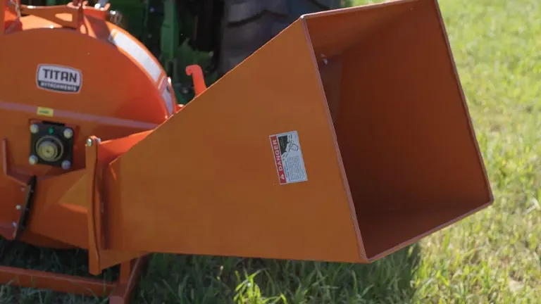 Orange Titan 40 HP 3-Point Wood Chipper Attachment on green grass