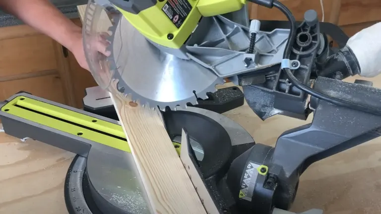 Person using a miter saw in workshop