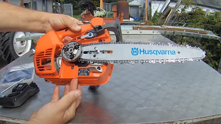 Person holding a Husqvarna T525 Chainsaw outdoors