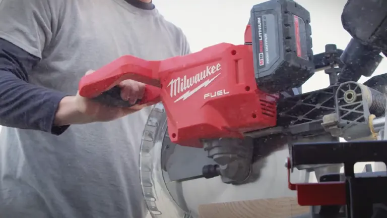 Person using a Milwaukee 2739-20 M18 FUEL 12” Dual Bevel Sliding Compound Miter Saw