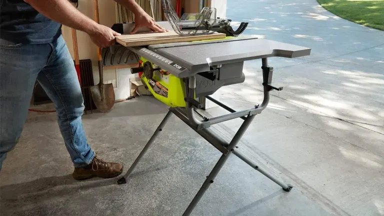 man cutting plywood using  Ryobi 10 in. Table Saw with Folding Stand (RTS12) 