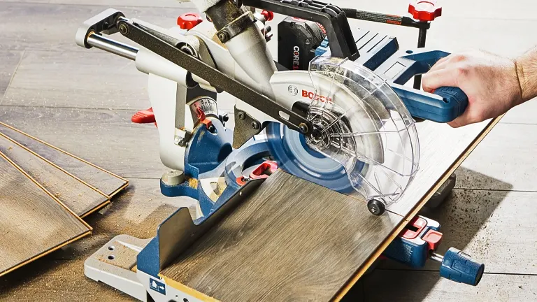 Person using a BOSCH PROFACTOR 18V sliding miter saw to cut wood