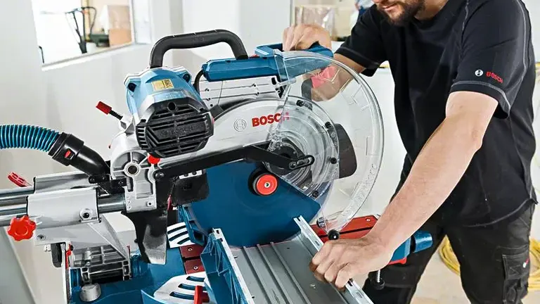 Person using Bosch GCM12SDE 12” Professional Glide Miter Saw in a workshop