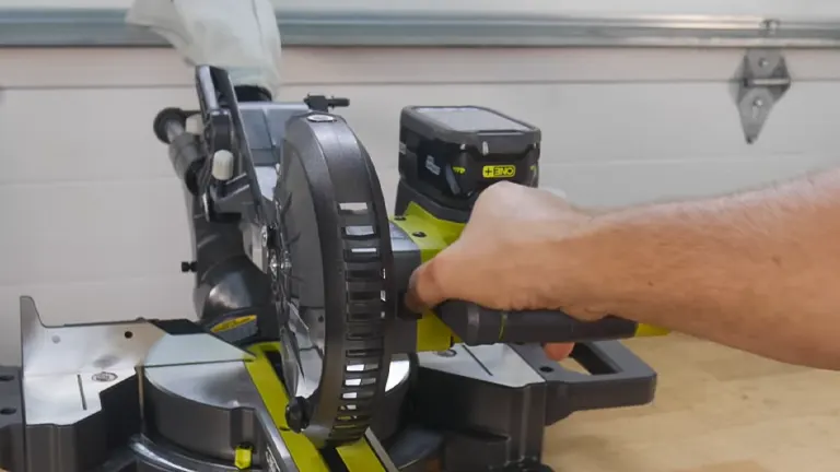 A Ryobi PBT01B ONE+ 18V 7-1/4” Sliding Compound Miter Saw being used in a workshop