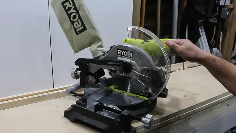 Person operating a Ryobi TS1144 9 Amp Corded 7-1/4” Compound Miter Saw on a workbench
