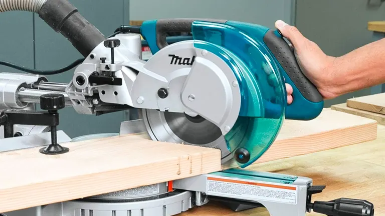 Makita 8-1/2” Single Bevel Sliding Compound Miter Saw in use on a wooden board