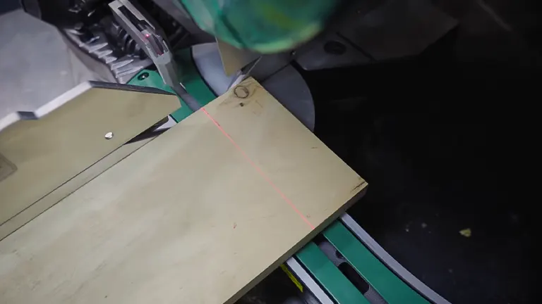 Metabo HPT C12RSH2S 12” Dual-Bevel Sliding Compound Miter Saw with Laser Marker cutting a wooden board in a workshop