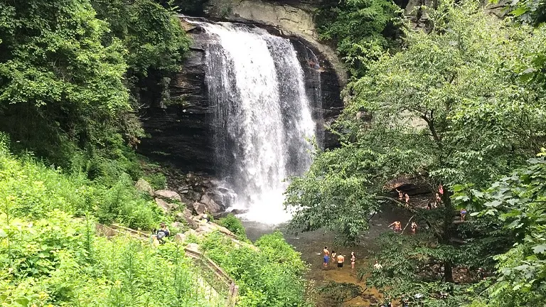 Waterfall at Pisgah National Forest with people enjoying the natural beauty