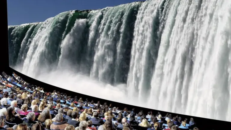 Audience watching Niagara Falls on a large outdoor screen at Niagara Falls State Park