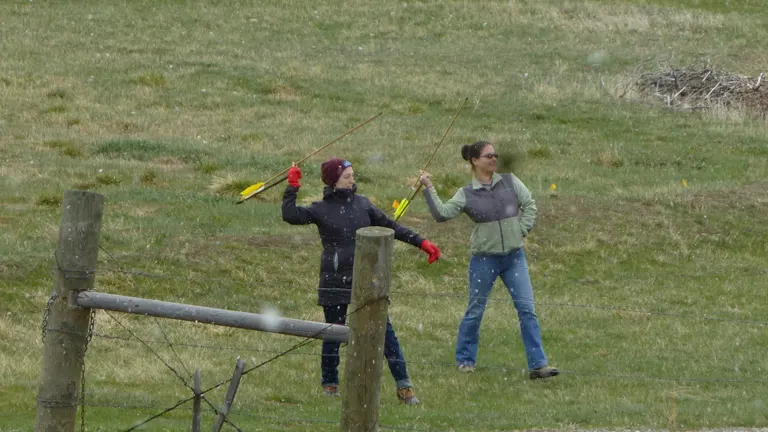Two people practicing archery at Pictograph Cave State Park