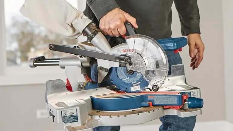 Person operating a BOSCH GCM18V-07SN PROFACTOR 7-1/4” Single-Bevel Slide Miter Saw in a well-lit workspace