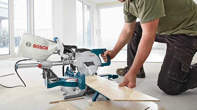 Person using a BOSCH CM8S 8-1/2” Single Bevel Sliding Compound Miter Saw at a construction site