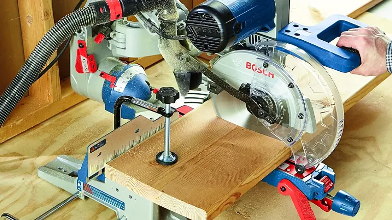 Person using a BOSCH CM10GD 10” Dual-Bevel Sliding Miter Saw to cut a wooden plank