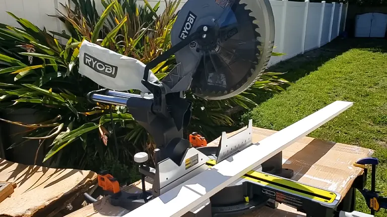 Ryobi 12” Sliding Compound Milter Saw on a wooden workbench in a garden setting