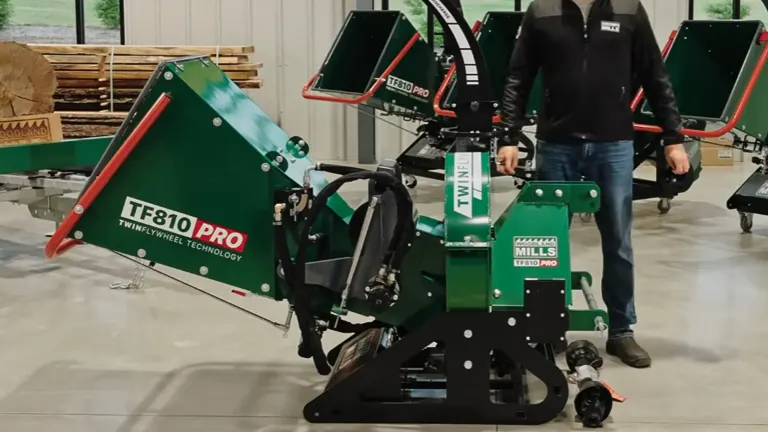 Green and black Woodland Mills TF810 PRO PTO Wood Chipper with ‘TWIN FLYWHEEL TECHNOLOGY’ label