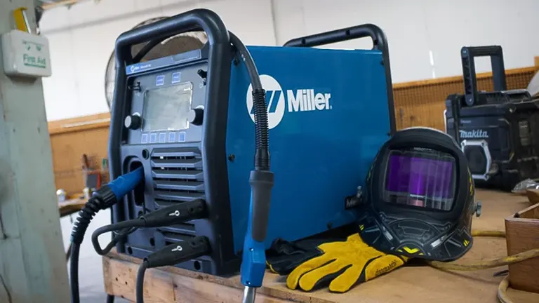 Millermatic 255 MIG welding machine with accessories in a workshop