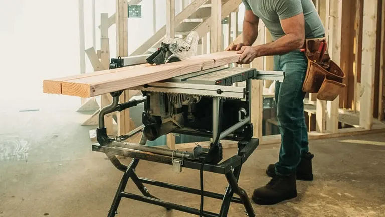 Man using SKIL SPT99T-01 8-¼-Inch Portable Table Saw to cut wood in workshop