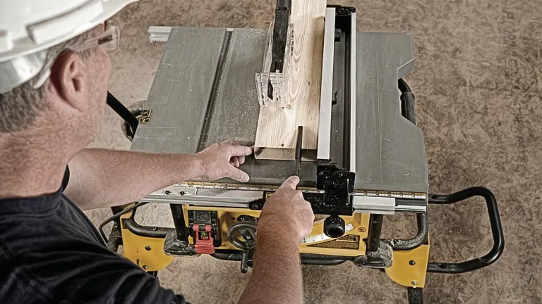Person using a DEWALT DWE7491RS 10-Inch Table Saw to cut wood