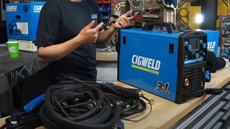 Person presenting the Cigweld Weldskill 3-in-1 Welder in a workshop