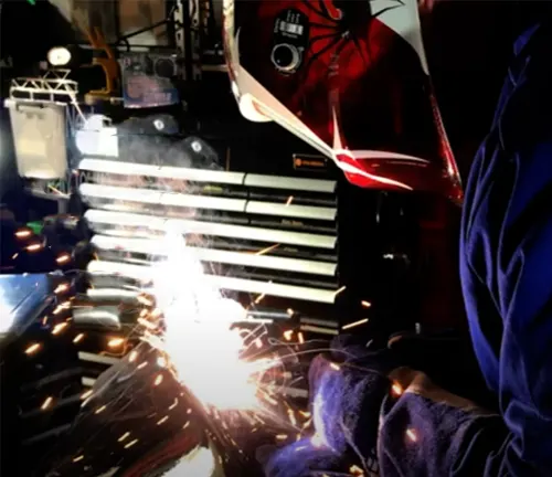 Welder using a Cigweld Weldskill 3-in-1 Welder to weld metal, producing bright sparks