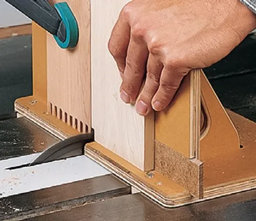 Person using box joint jig for precision cuts on table saw