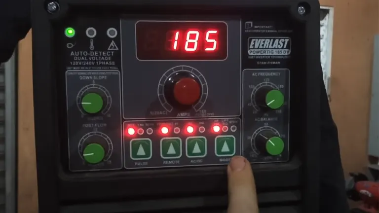 A person adjusting settings on an Everlast Power 185DV AC/DC TIG Stick Welder