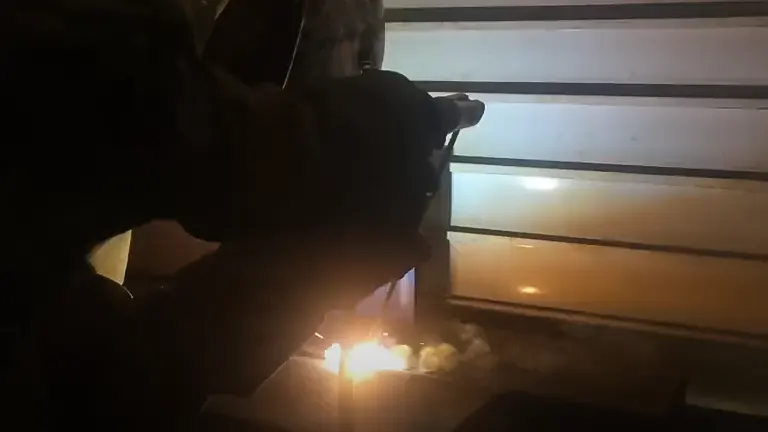 A person welding metal with bright sparks using an Everlast Power 185DV AC/DC TIG Stick Welder