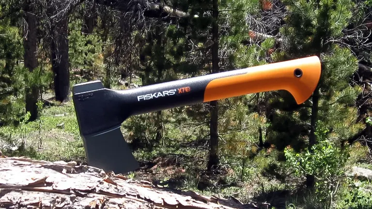 Fiskars X7 Hatchet with orange and black handle in a forest