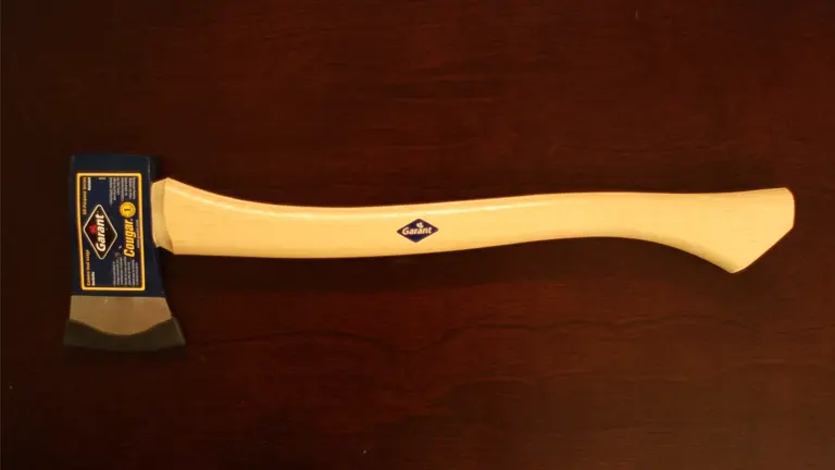 Garant Cougar Axe with a beige handle and blue-black head on a dark surface