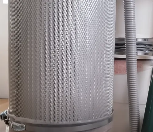Close-up view of a Grizzly 3 HP Portable Cyclone Dust Collector with a flexible, ribbed hose in a workshop