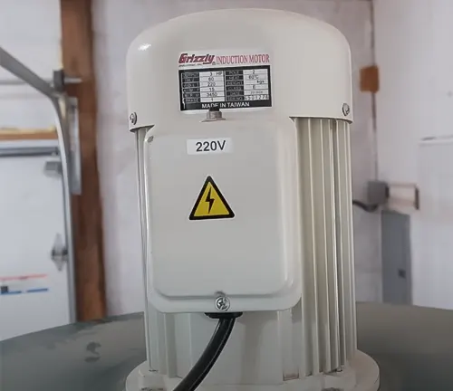 Grizzly 3 HP Portable Cyclone Dust Collector motor with a warning label in a workshop