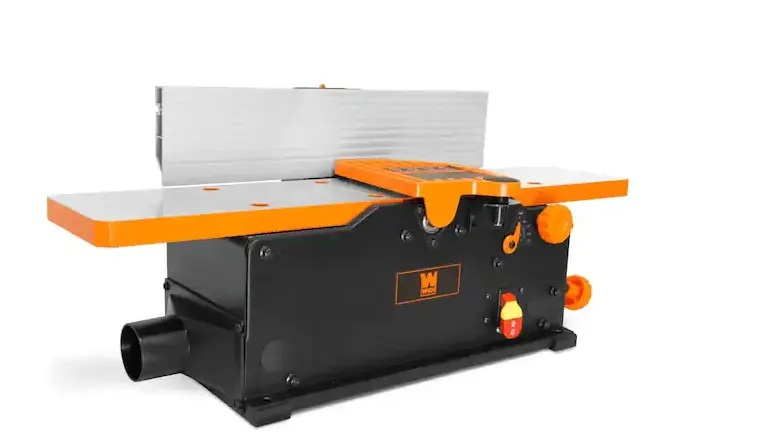 Orange and black Grizzly Industrial G0945 6-inch Benchtop Jointer with a safety guard