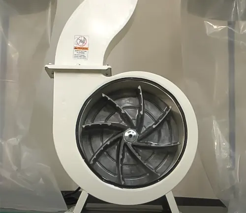 Grizzly 3 HP Dust Collector with visible Aluminum Impeller and safety warning label, placed against a wall