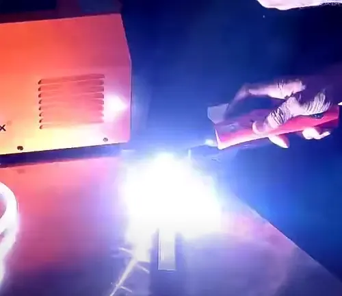Person using the HBT2000 TIG ARC Welding Machine, with bright light from the welding process