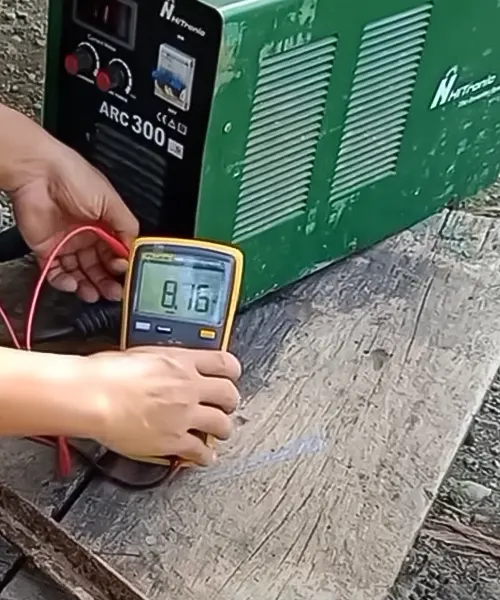 Person testing the Hitronic TIG 300A DC Inverter Welder with a digital multimeter