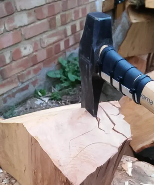Husqvarna S21 Wooden Handle Splitting Maul embedded in a wooden log