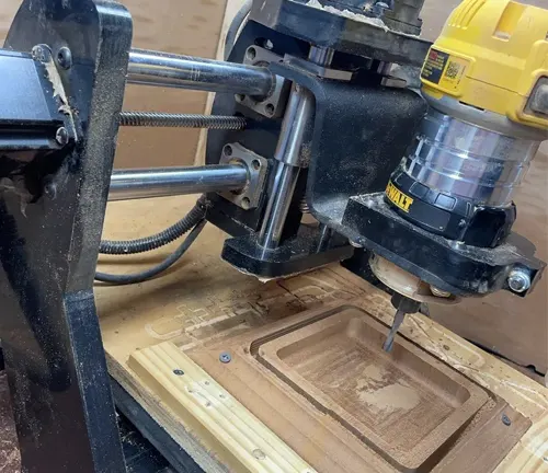 Close up of a CNC machine in operation, carving a wooden board