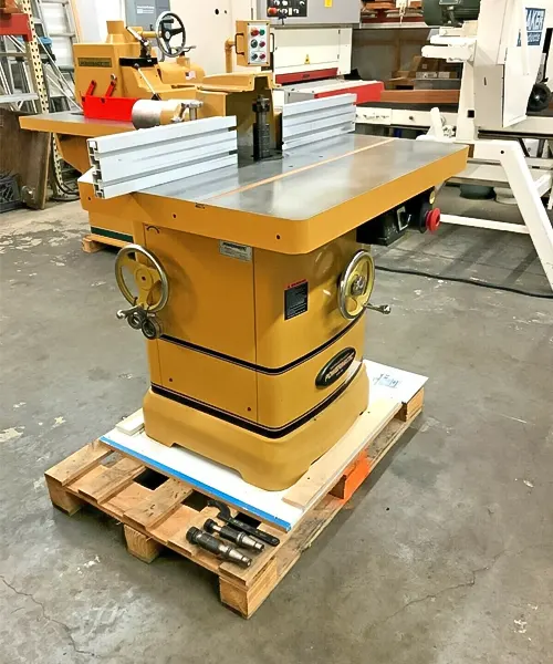 Powermatic 5HP Woodworking Shaper PM2700 with a large flat work surface, fence, miter gauge, and handwheels, in a workshop setting