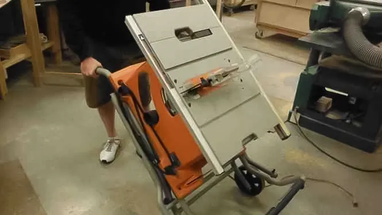 Person pushing a RIDGID 10 Inch Table Saw R4510 in a workshop