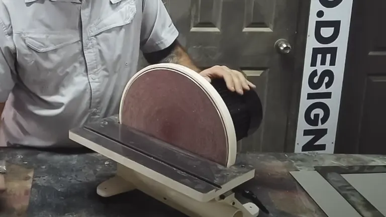 Person using white Shop Fox W1828 12-Inch Disc Sander in a workshop