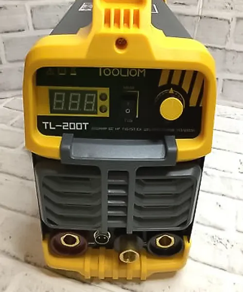 TOOLIOM 200A TIG 2-in-1 Welding Machine, model TL-200T, displayed against a white brick wall