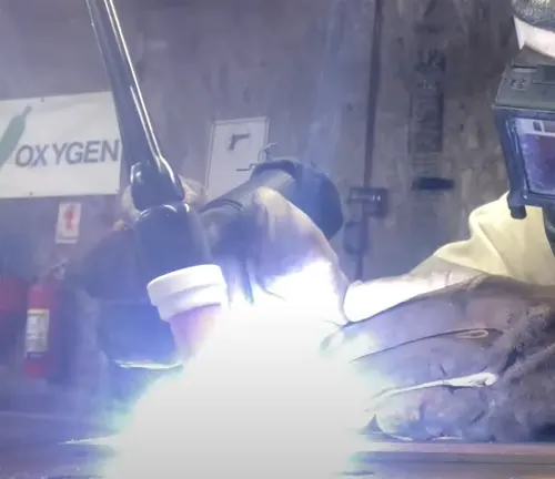 a welder using the Weldpro Digital TIG 200GD Welder Machine in a workshop