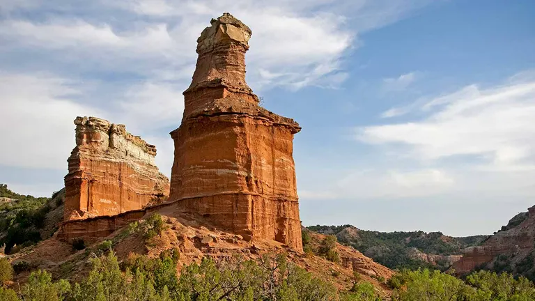 a towering red rock formation with distinct layers at Palo Duro Canyon State Park