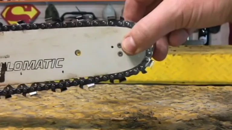 person’s hand adjusting the chain on a chainsaw labeled “LOMATIC”, illustrating the process of chain adjustment