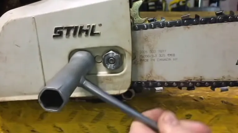 person using a socket wrench to tighten the bar nuts on a STIHL chainsaw, illustrating the process of securing the bar nuts