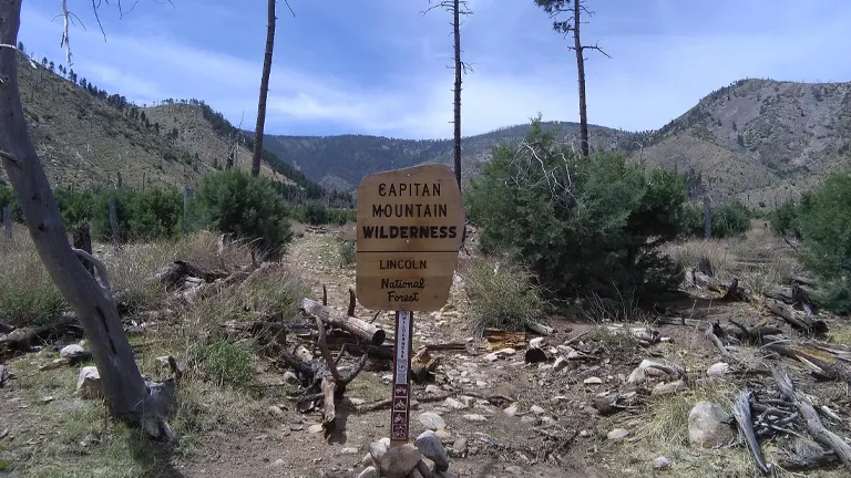 wilderness area with a prominent wooden sign that reads “Capitan Mountain Wilderness, Lincoln National Forest”