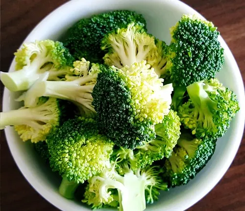 white bowl filled with bright green broccoli florets