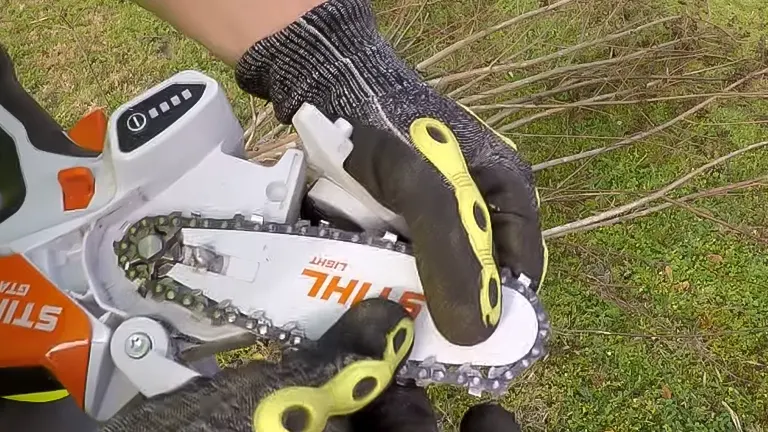 Person wearing protective gloves using a STIHL GTA 26 mini chainsaw